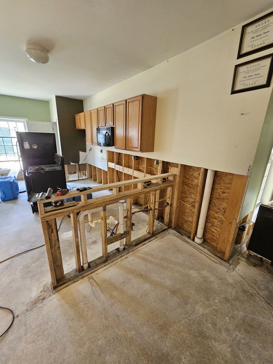 Kitchen opened up to the framing after a water loss, ready for drying