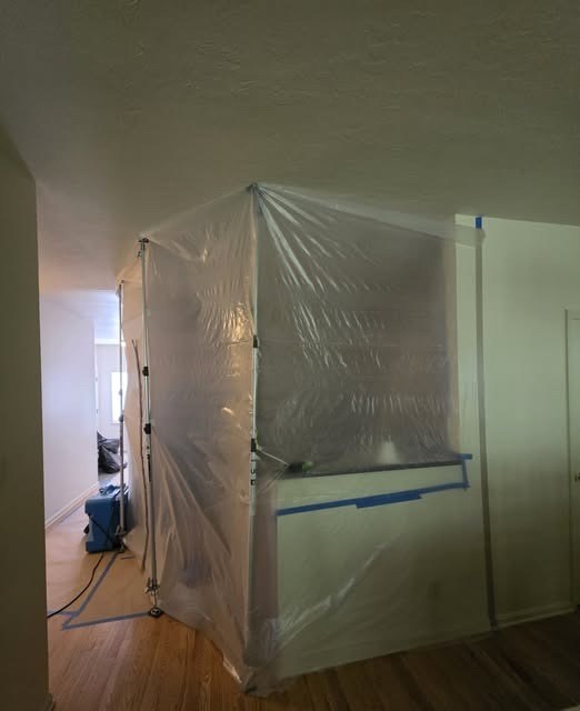 Plastic containment sealing off a work area in a hallway